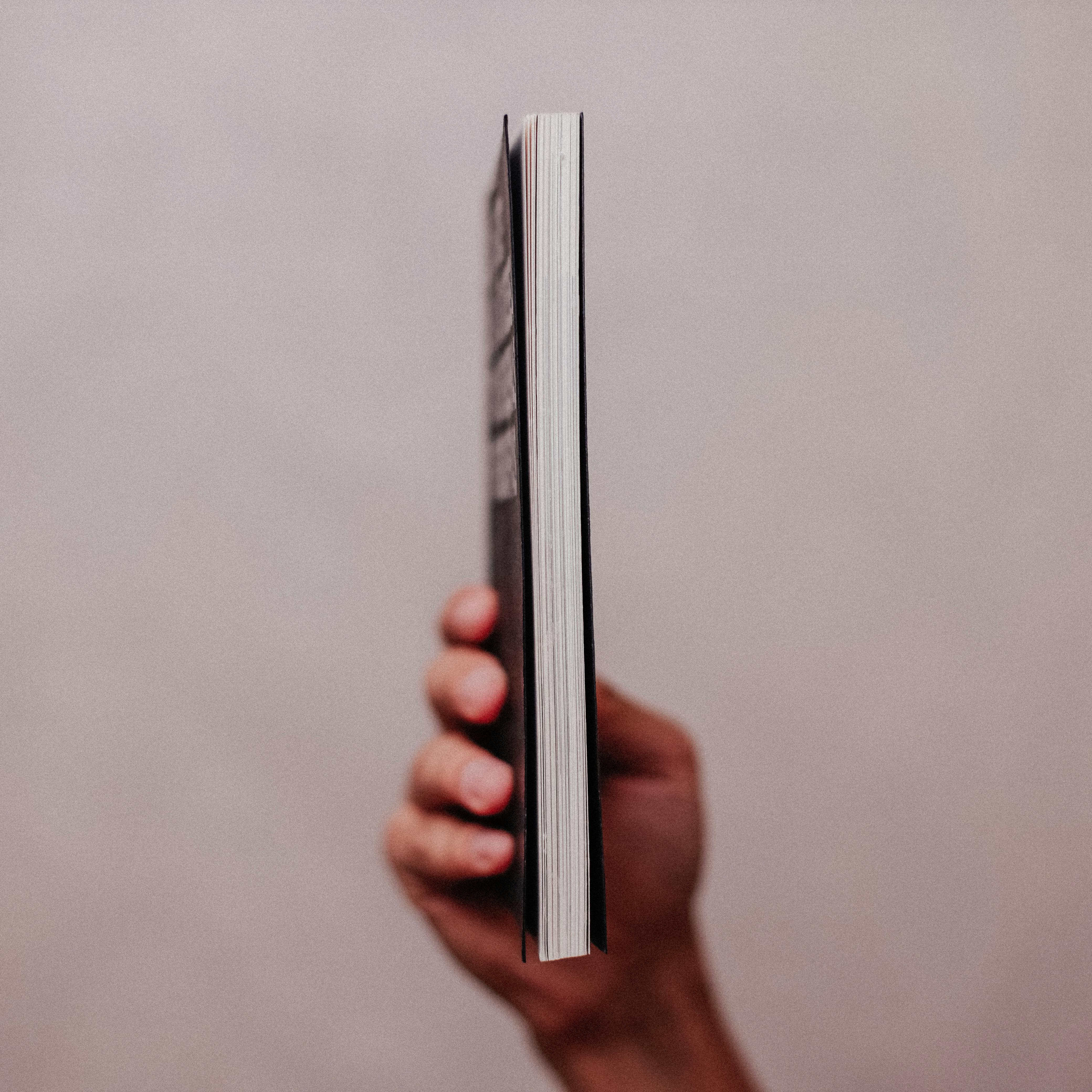 A hand holding a book